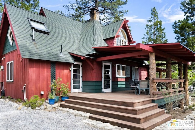 back of house with a wooden deck