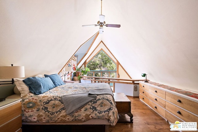 bedroom with hardwood / wood-style flooring, vaulted ceiling, and ceiling fan