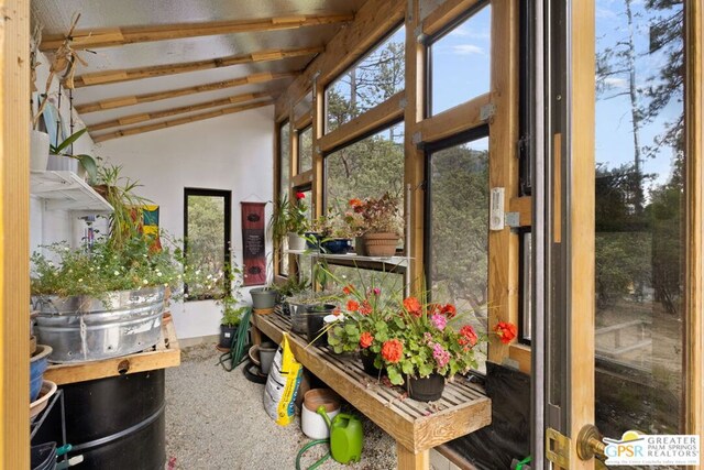 sunroom / solarium featuring a wealth of natural light and lofted ceiling with beams