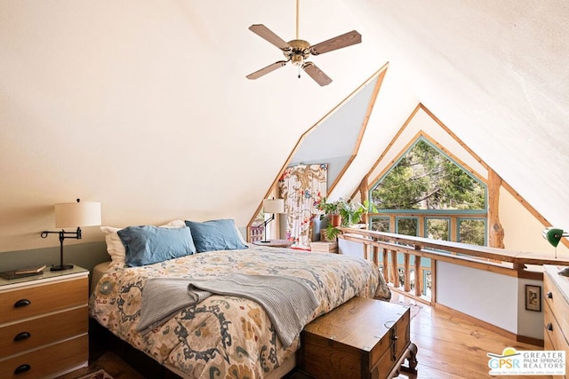 bedroom featuring ceiling fan, light hardwood / wood-style floors, and lofted ceiling