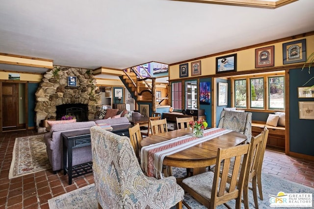 dining room with a stone fireplace