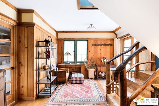 interior space with light hardwood / wood-style floors, a wealth of natural light, and crown molding