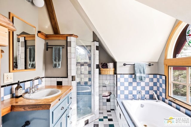 bathroom with a wealth of natural light, vaulted ceiling with beams, independent shower and bath, and vanity