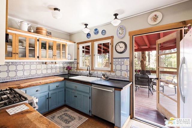 kitchen featuring a wealth of natural light, sink, tasteful backsplash, and stainless steel appliances