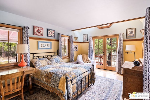 bedroom with light hardwood / wood-style floors, access to outside, and french doors