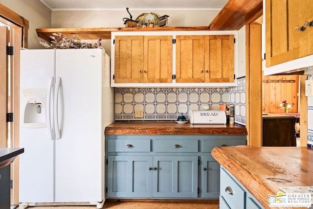 kitchen featuring backsplash, butcher block counters, and white fridge with ice dispenser