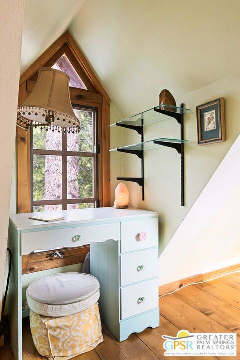 interior space with lofted ceiling and hardwood / wood-style floors