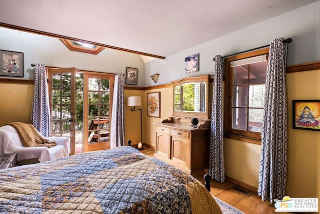 bedroom with light wood-type flooring and access to exterior