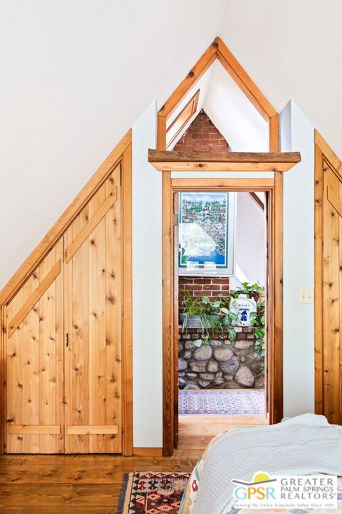 doorway to outside with light hardwood / wood-style floors and vaulted ceiling