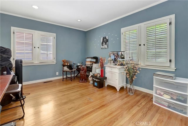 office featuring light hardwood / wood-style flooring and crown molding