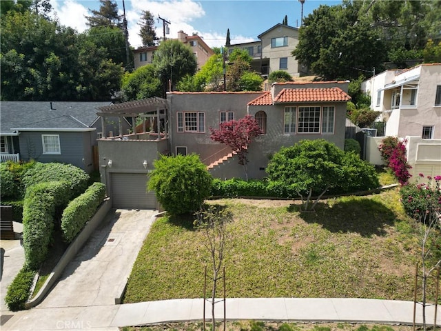 view of front facade featuring a pergola and a garage