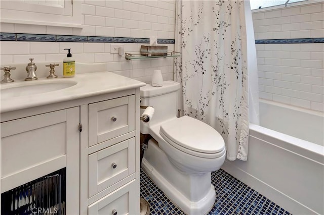 full bathroom featuring vanity, tile patterned floors, shower / bath combination with curtain, toilet, and tile walls