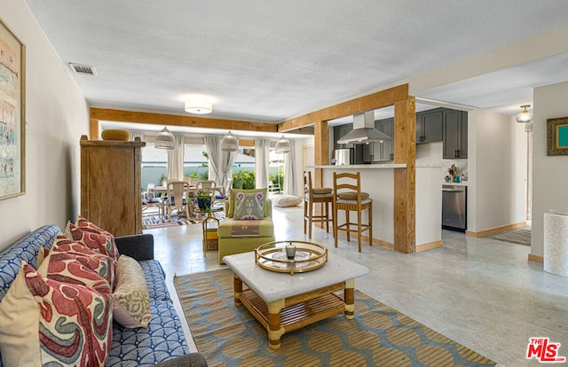 living room with a textured ceiling and concrete floors