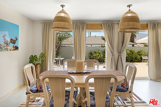 dining space featuring concrete floors