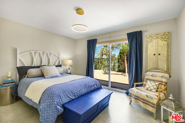 bedroom featuring concrete flooring and access to outside