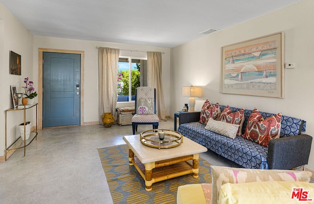 living room featuring concrete flooring