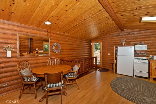 dining room with lofted ceiling with beams, light hardwood / wood-style floors, log walls, and wooden ceiling