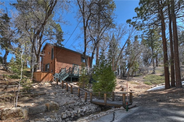 view of side of property featuring a wooden deck