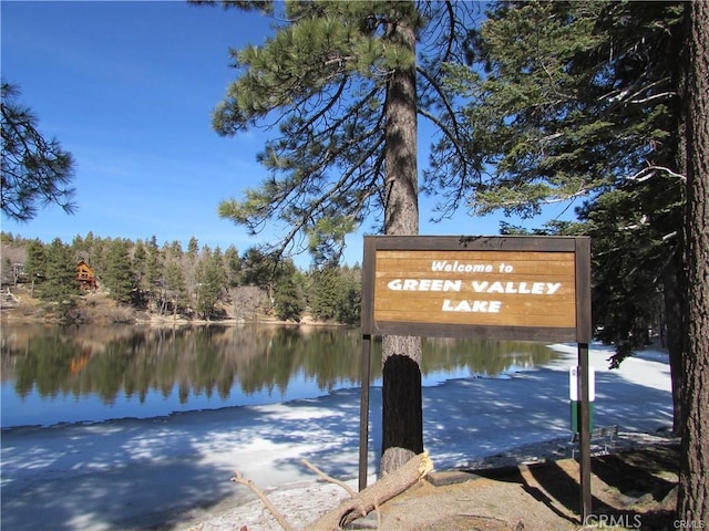 community / neighborhood sign with a water view