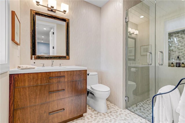 bathroom with vanity, toilet, and an enclosed shower