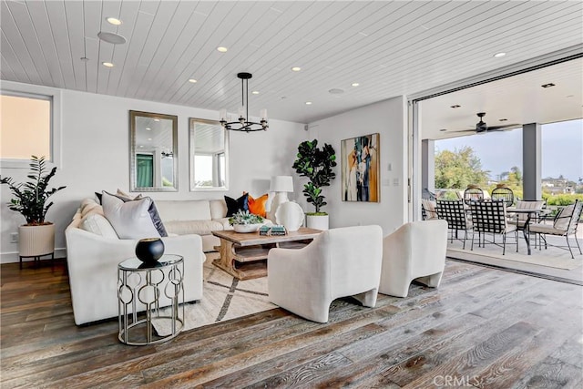 living room with a notable chandelier, hardwood / wood-style floors, and wooden ceiling