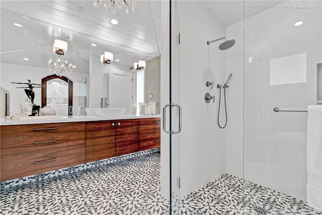 bathroom with vanity and a shower with door