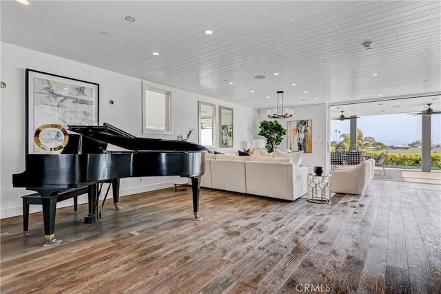 living room featuring ceiling fan with notable chandelier, hardwood / wood-style floors, and wooden ceiling