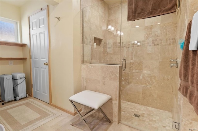 bathroom with a shower with door, radiator, tile floors, and tile walls