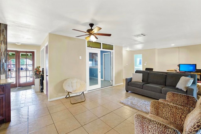 tiled living room with french doors and ceiling fan