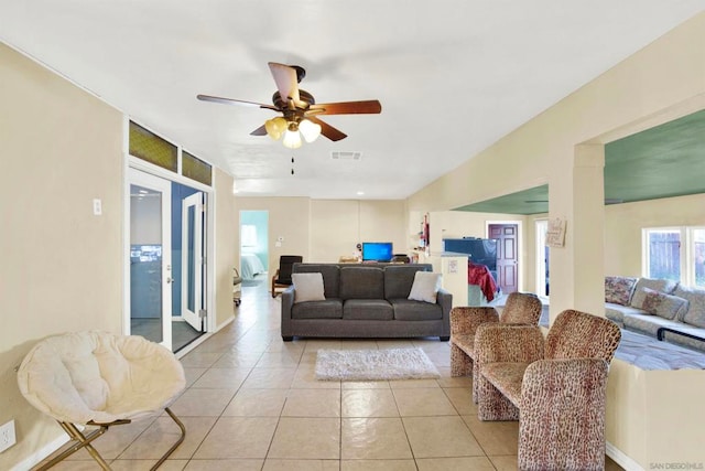 tiled living room with ceiling fan