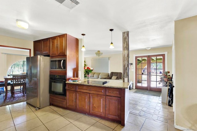 kitchen with light stone countertops, french doors, kitchen peninsula, black appliances, and decorative light fixtures