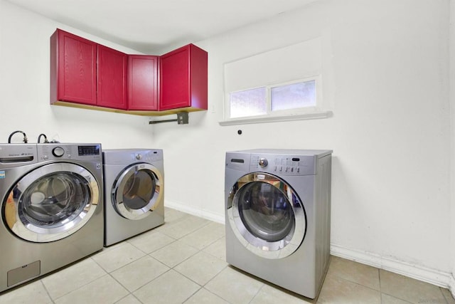 clothes washing area featuring light tile patterned flooring and washing machine and dryer