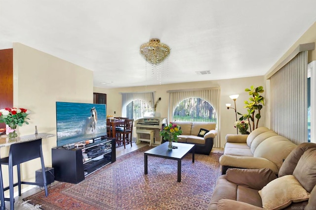 living room with wood-type flooring and an inviting chandelier