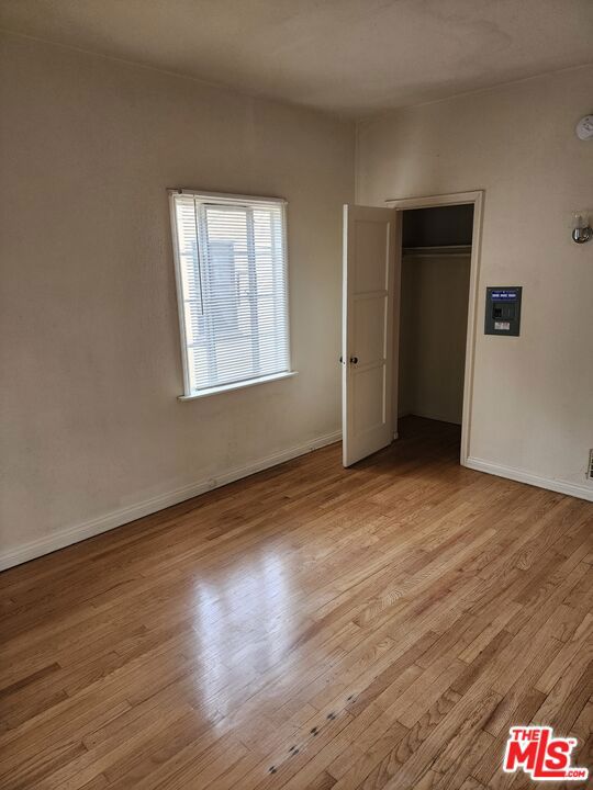 unfurnished bedroom featuring a closet and light hardwood / wood-style floors