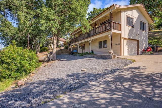 view of front of property with a garage and a balcony