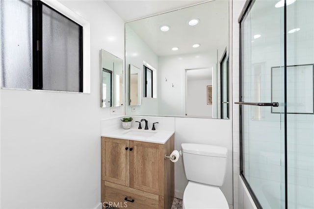 full bathroom featuring vanity, toilet, and enclosed tub / shower combo