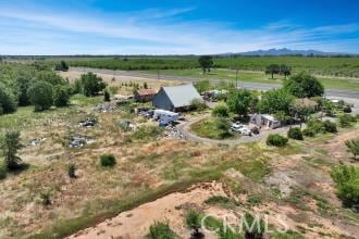 birds eye view of property with a rural view