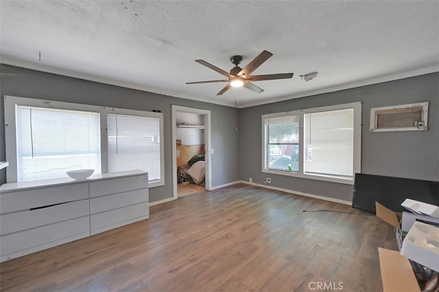 unfurnished bedroom featuring ceiling fan, multiple windows, and a closet