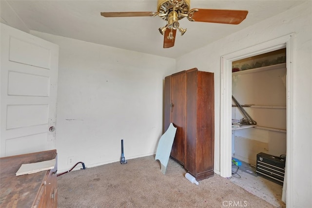 unfurnished bedroom with ceiling fan and light colored carpet