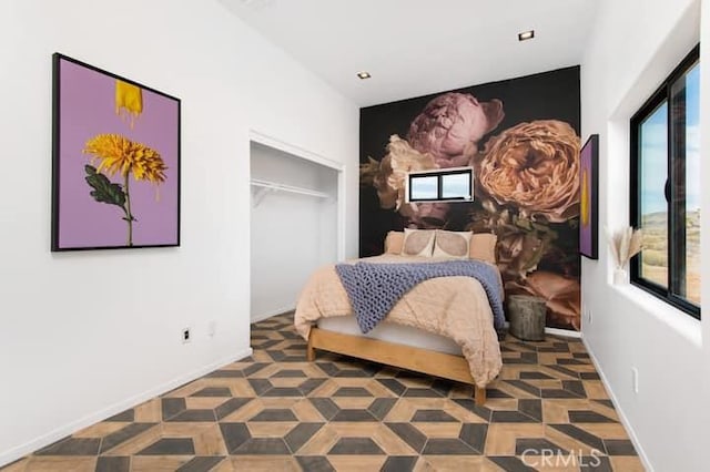 bedroom with a closet and multiple windows