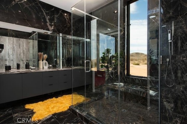 bathroom with a shower with door and vanity