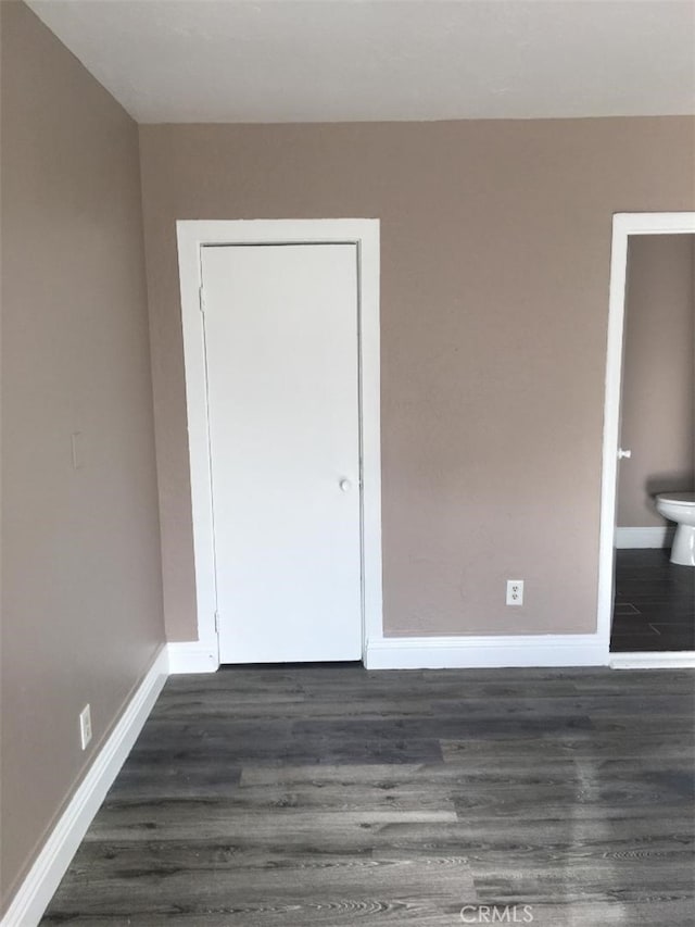 222 F St, Needles, CA 92363 - unfurnished bedroom featuring dark wood-type flooring and baseboards