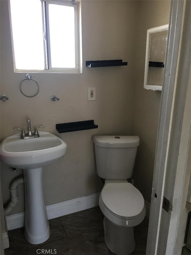222 F St, Needles, CA 92363 - bathroom featuring toilet, baseboards, a sink, and tile patterned flooring