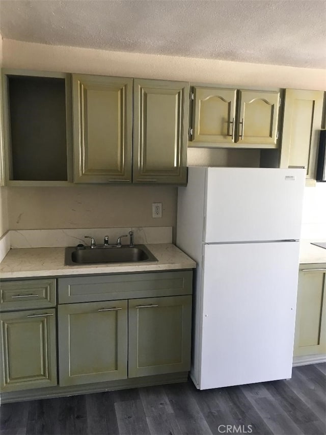 222 F St, Needles, CA 92363 - kitchen with freestanding refrigerator, a sink, light countertops, dark wood finished floors, and a textured ceiling