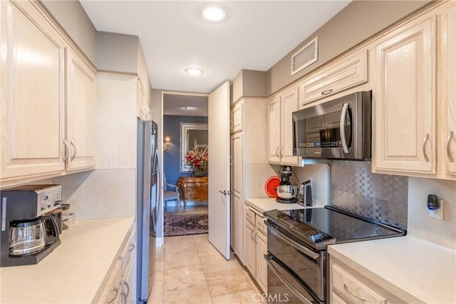 kitchen featuring recessed lighting, visible vents, light countertops, appliances with stainless steel finishes, and backsplash