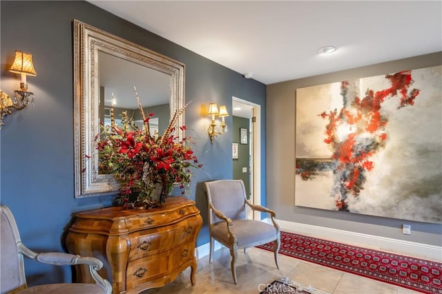 living area featuring light tile patterned flooring and baseboards