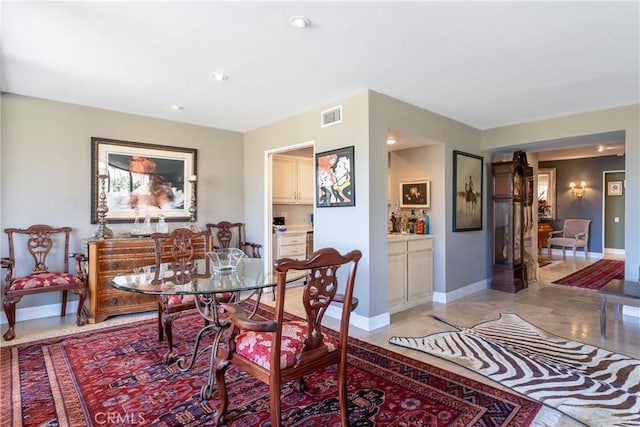 dining space with baseboards and visible vents