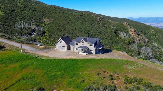 birds eye view of property with a mountain view