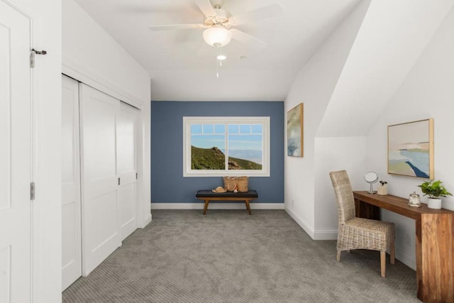 interior space featuring ceiling fan, light colored carpet, and vaulted ceiling