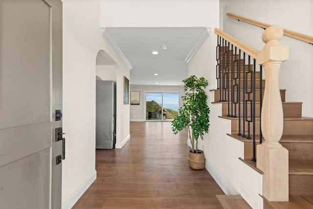 hallway with dark hardwood / wood-style flooring and crown molding